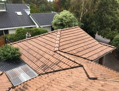 Damaged roof being inspected by a contractor in Norfolk, VA