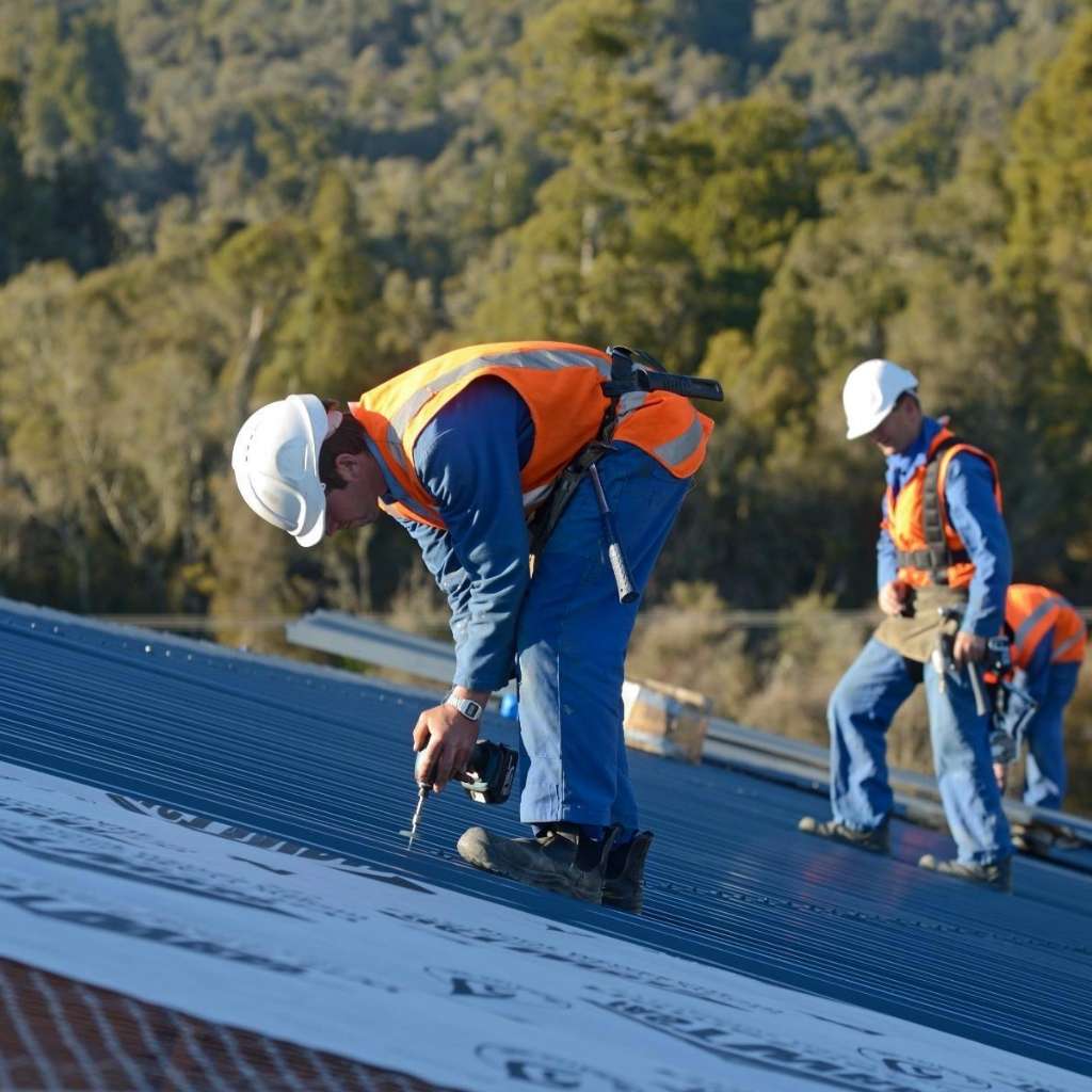 Best roofing company near Hampton VA crew installing metal roof.