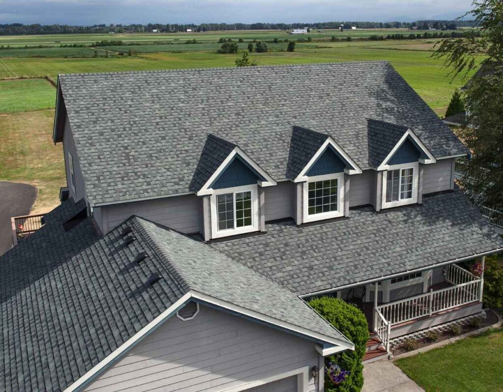 Residential roof replacement by a Residential roofing Portsmouth with architectural gray shingles and dormers.