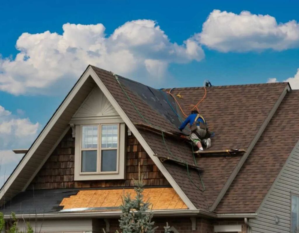 Residential roof replacement by a Metal roofing Portsmouth VA installing brown dimensional asphalt shingles.